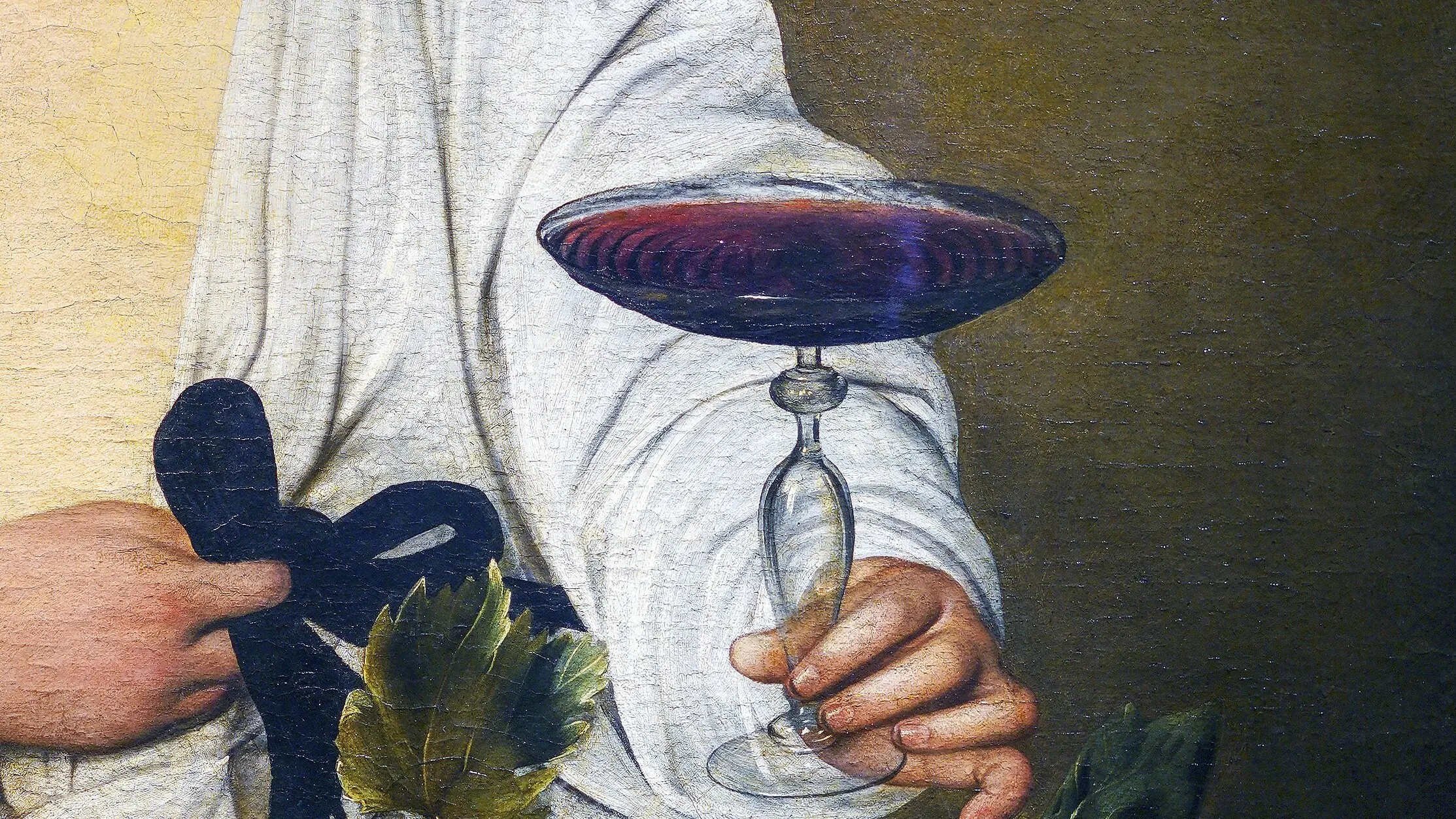 Detail of Caravaggio, Bacchus: a hand holding a glass of red wine